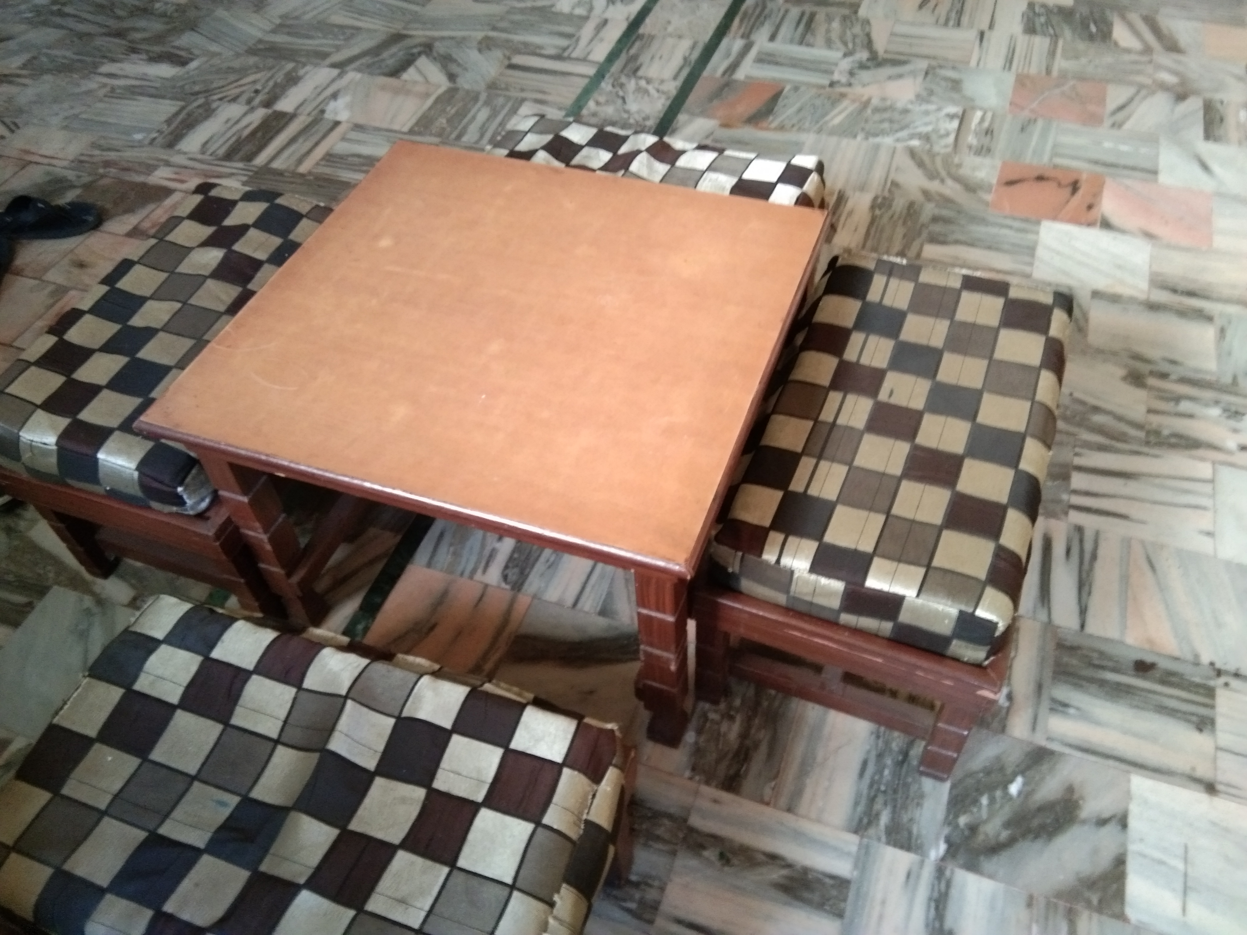 A wooden table with 4 seat available for sale