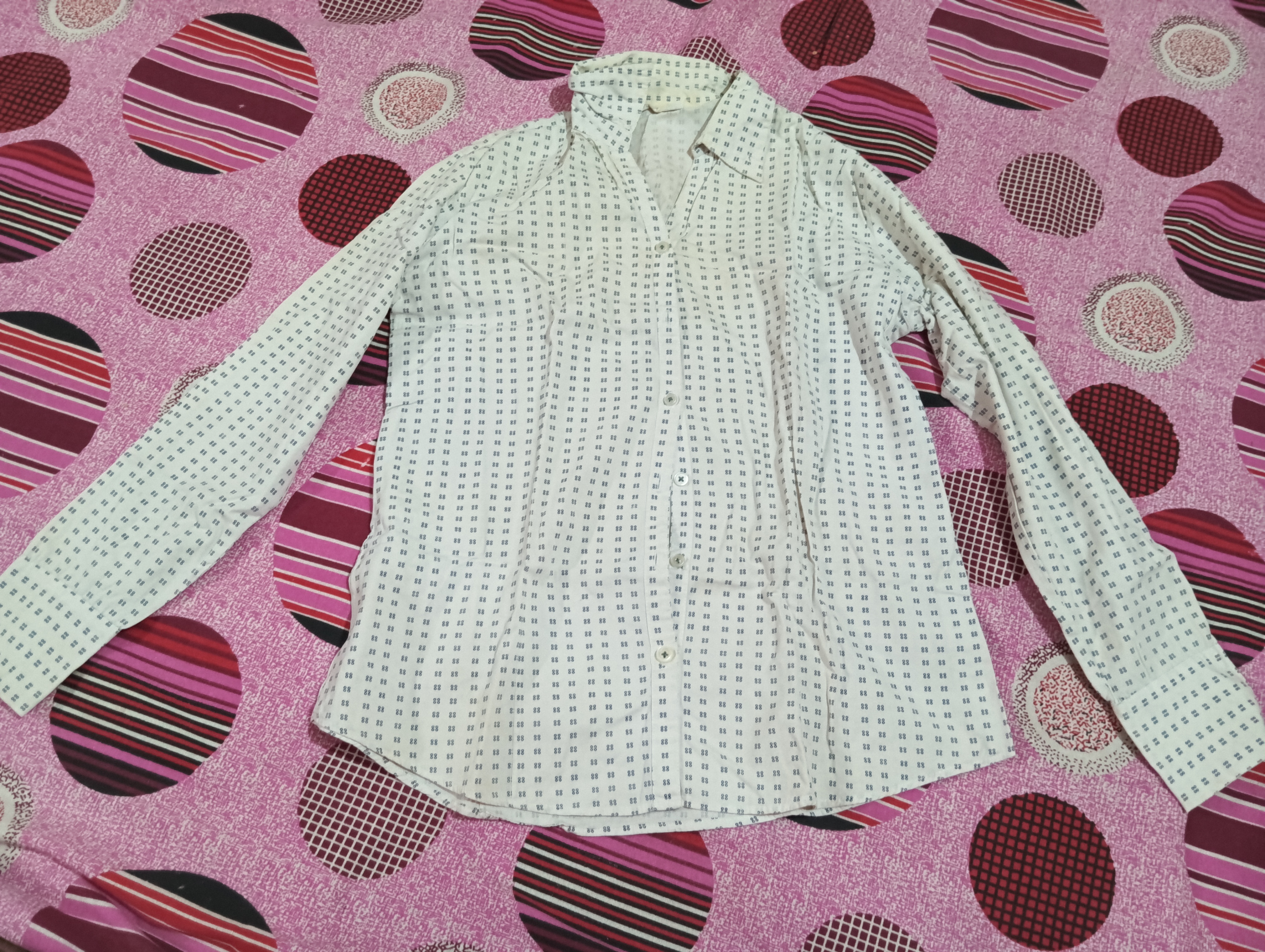 A white shirt for women in small size having blue dots design on it  available for sale